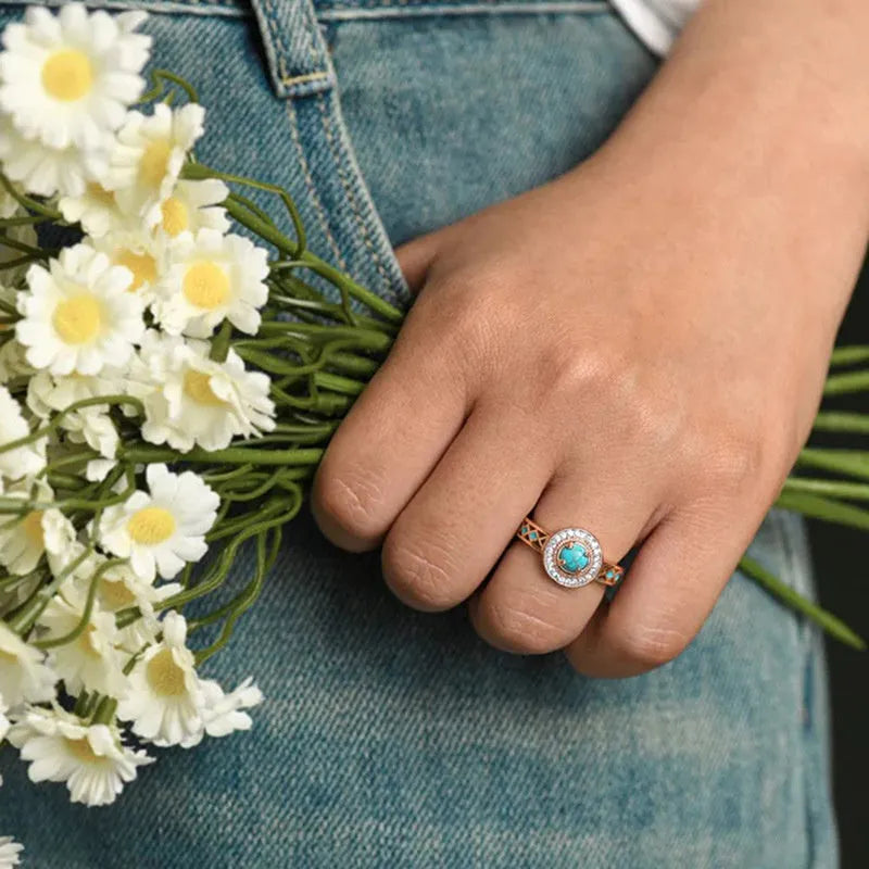 Women's rose gold copper ring with turquoise stone and geometric zircon inlay design.