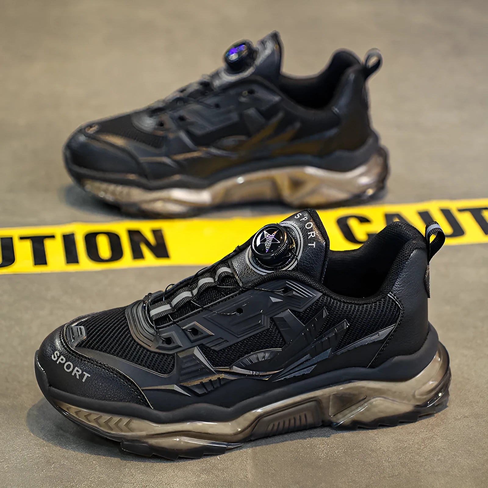 Men's black casual sneakers with rotating button closure and mesh upper on rubber sole.
