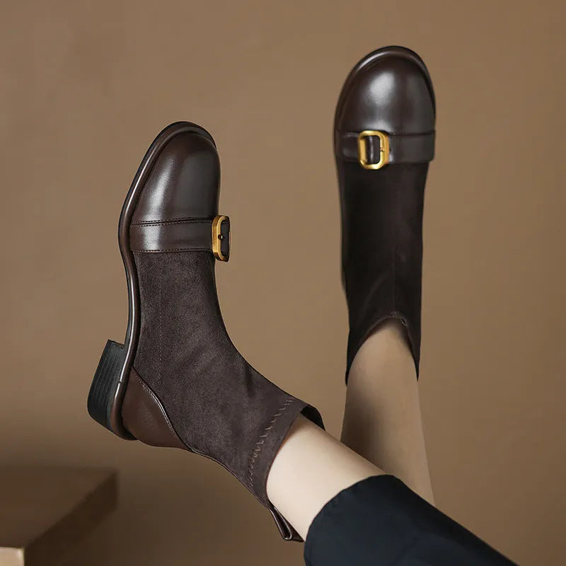 Women's black low heel Martin ankle boots with lace-up front and buckle stitch detail on a white background.