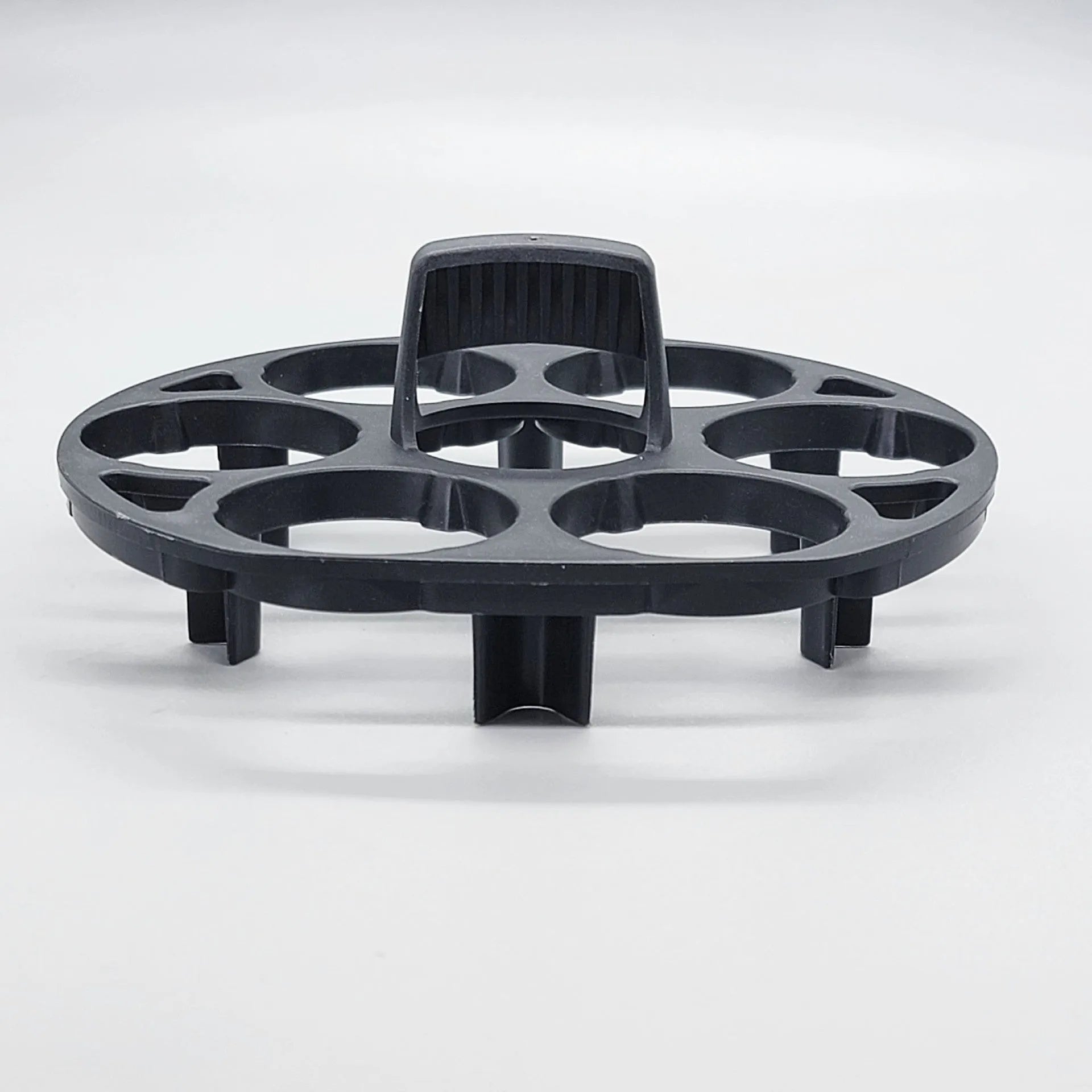 Black plastic egg holder rack with modern design for kitchen organisation.