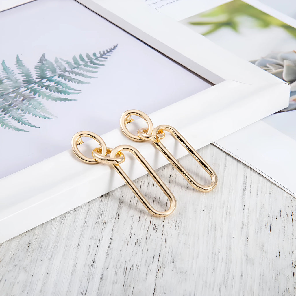 Geometric sterling silver needle hoop earrings with ring and line design elements