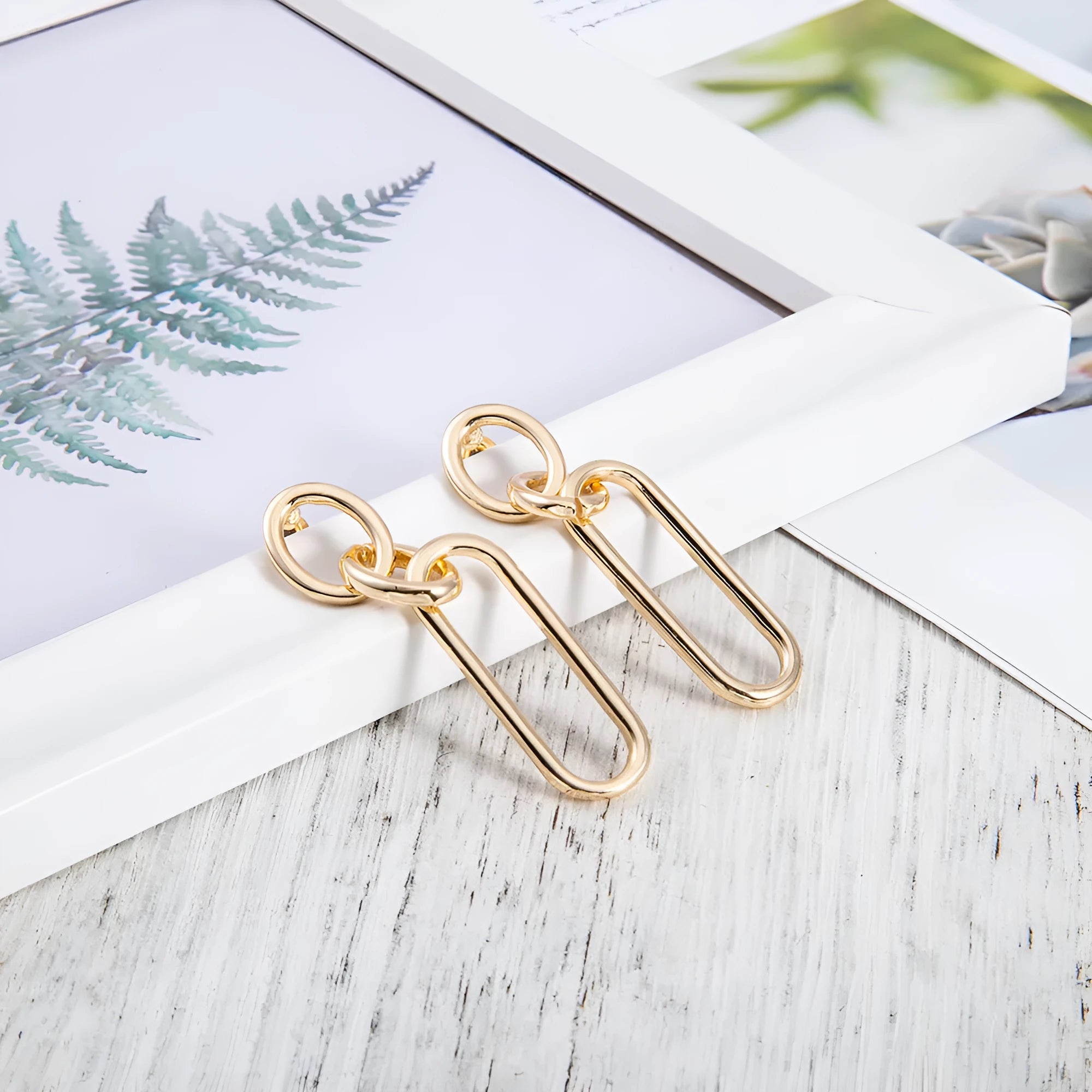 Geometric sterling silver needle hoop earrings with ring and line design elements
