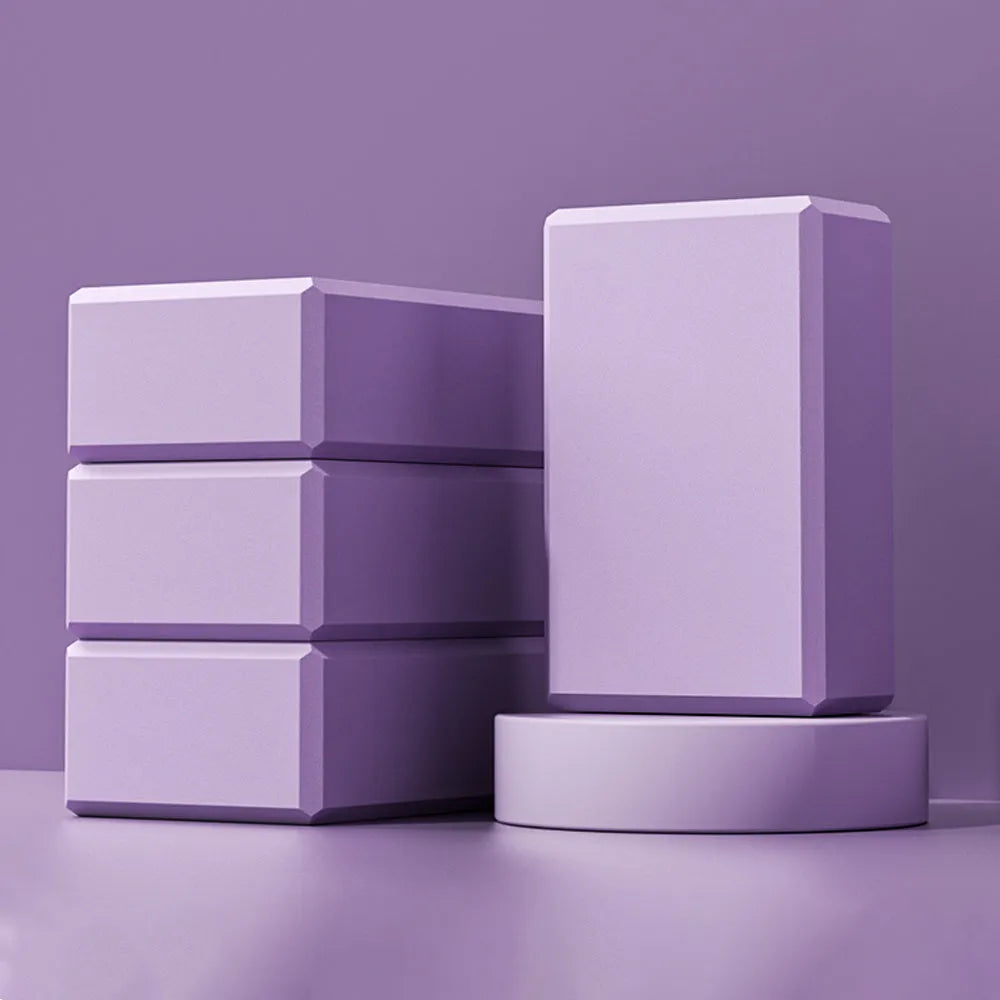 EVA foam yoga blocks in four colours showing hexagonal facets and ridge grip details