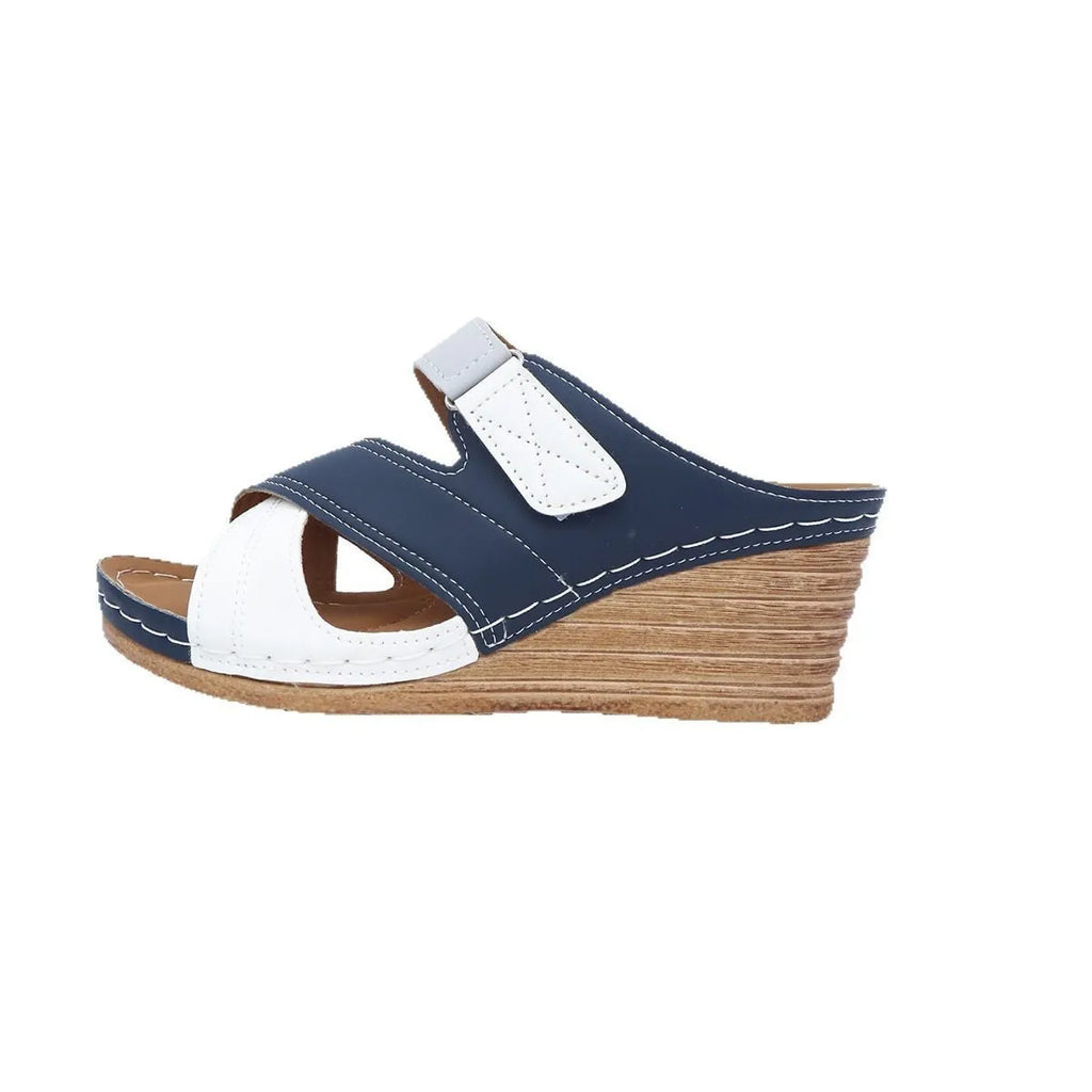 Women's black and white platform wedge slippers with a Velcro strap and fish mouth toe design.