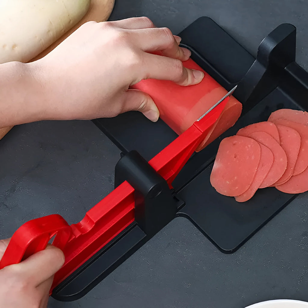 Green and red plastic vegetable cutter with stainless steel blades for slicing carrots and potatoes.