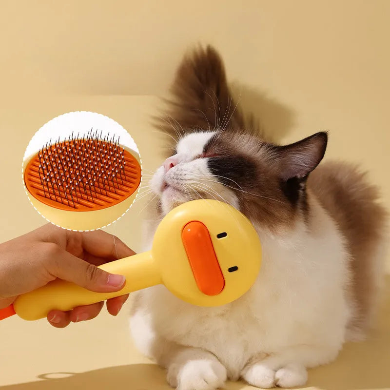 Small yellow duck-shaped pet comb with detachable needle teeth for cat and dog grooming.