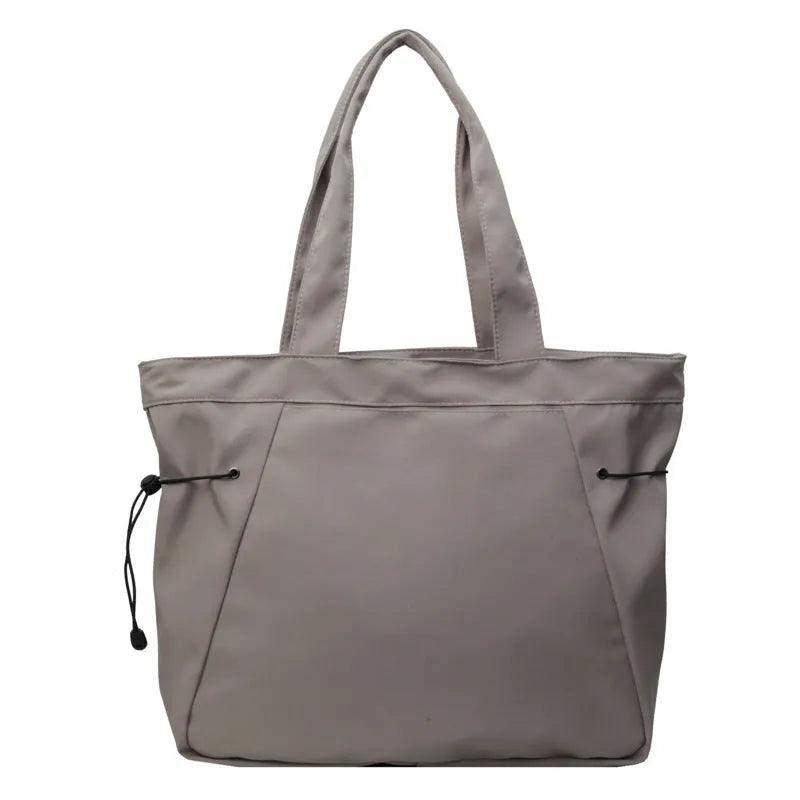 Soft Oxford cloth folding tote bag shown in a choice of five colours on a plain background.