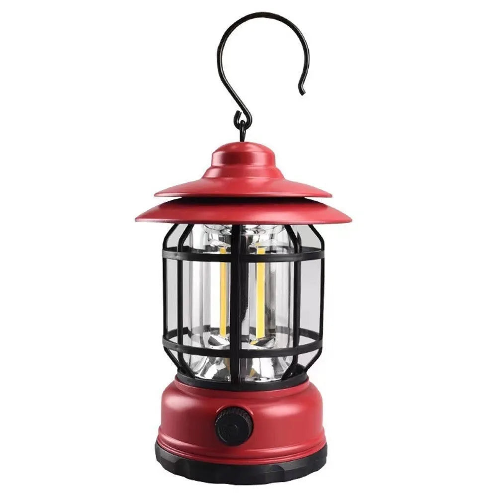 Portable dark green head lamp camping lantern shown on a table with super bright LED light on.