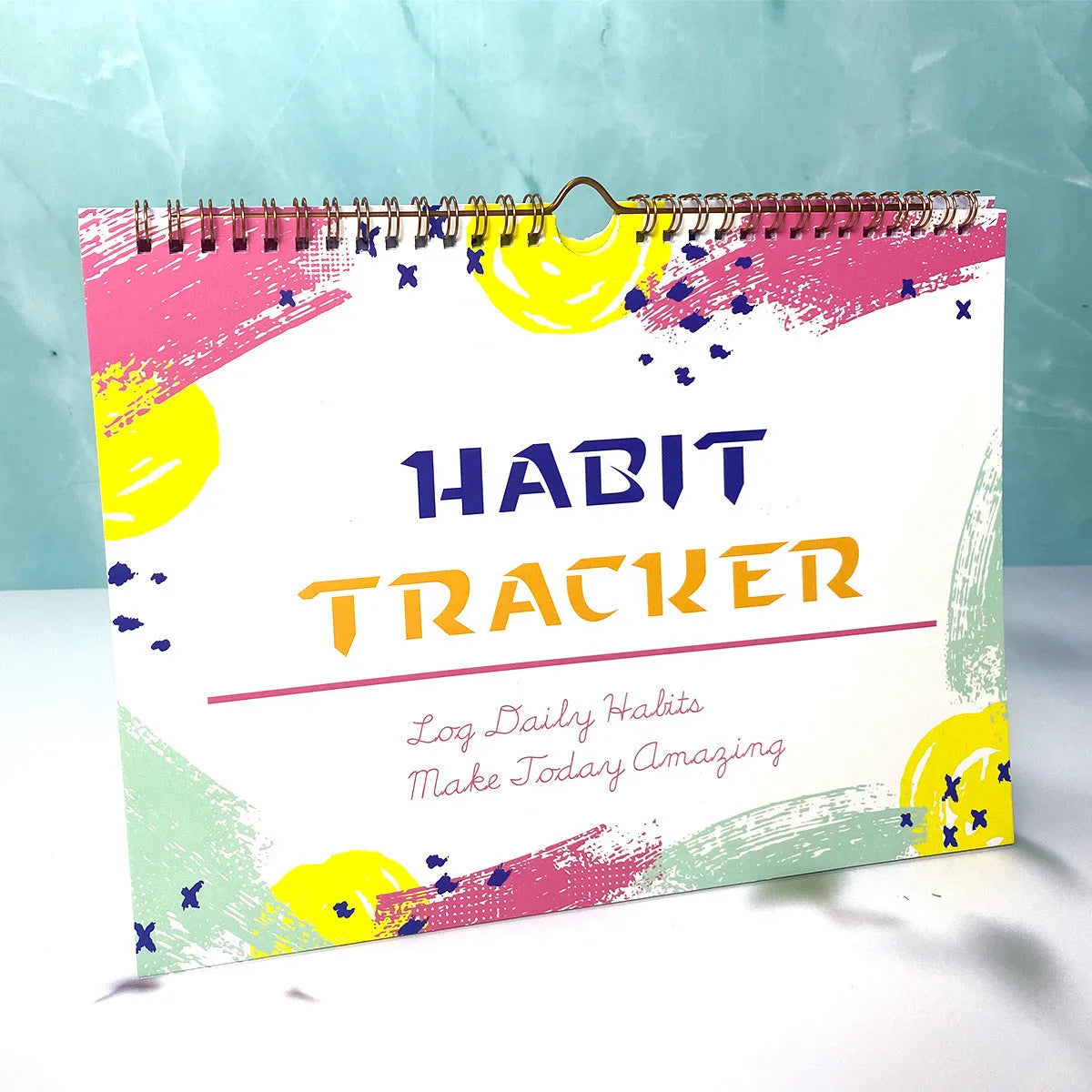 Habit tracking notebook open showing internal pages with 21x28cm dimensions in flower white cover colour