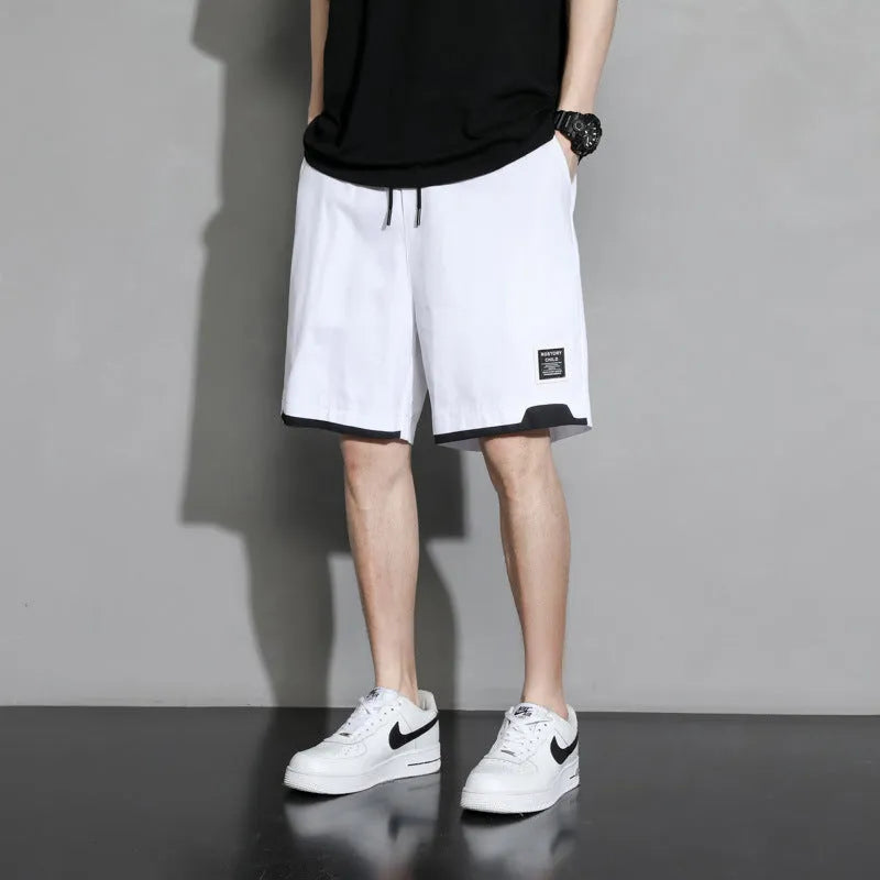 Cotton shorts for teenage boys in black, khaki, and white, showing mid-waist fit and shorts length.