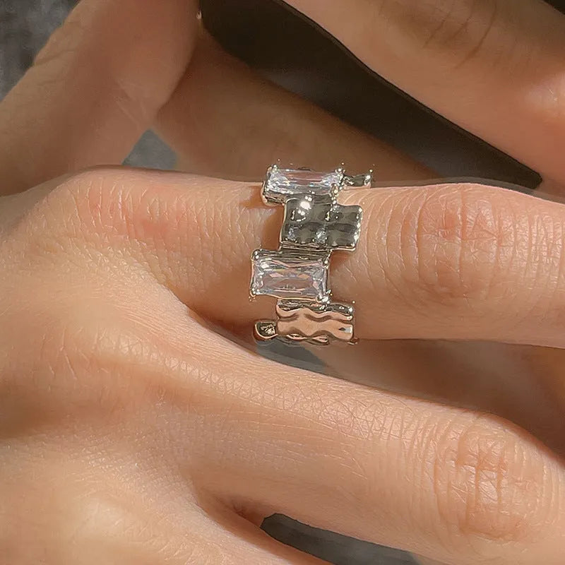 Silver geometric ring with cross zircon centre and open adjustable back