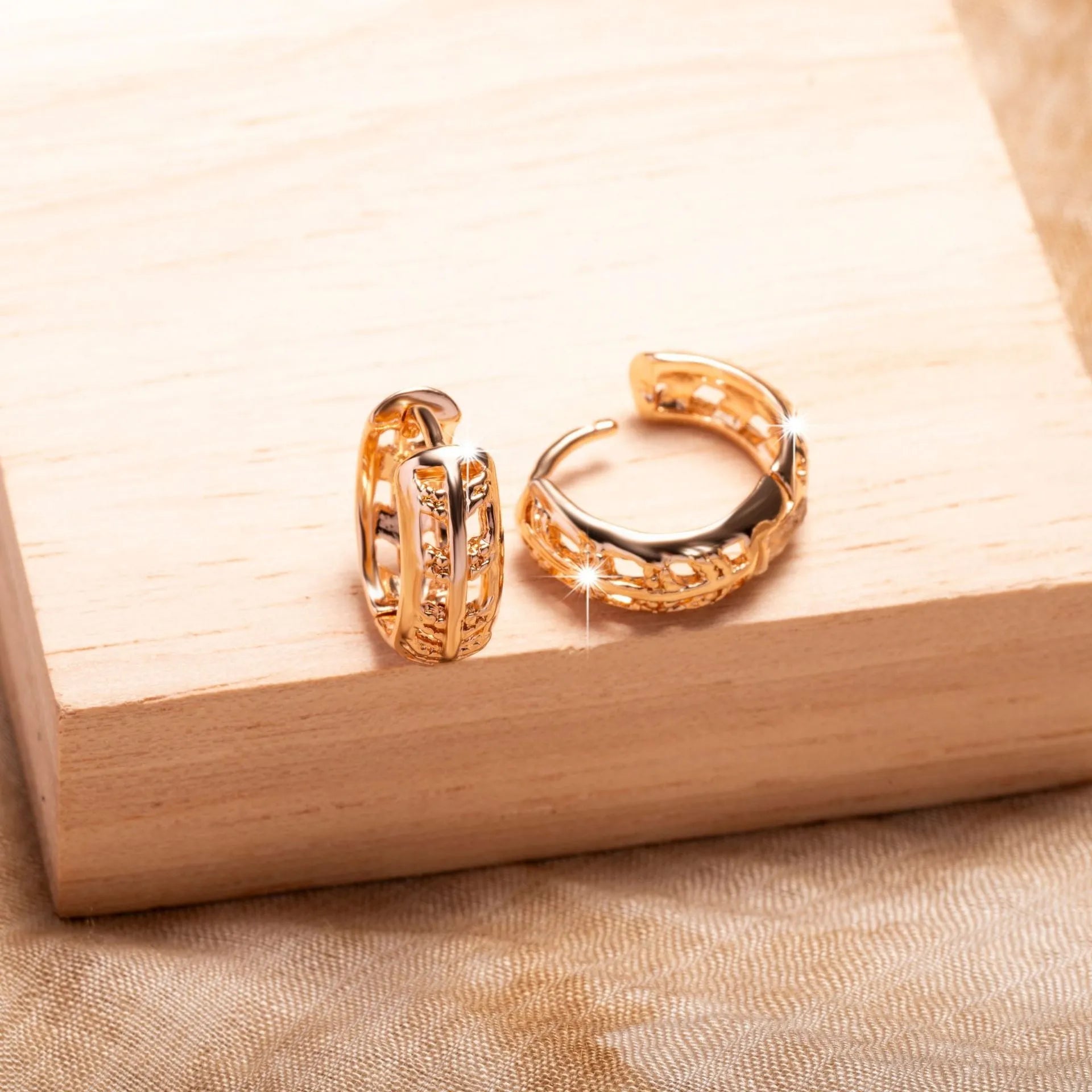 Rose gold hollowed leaf and heart shaped copper earrings on display