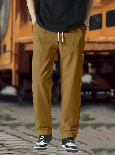 Men's polyester trousers in light grey colour, shown folded, for spring and autumn wear.