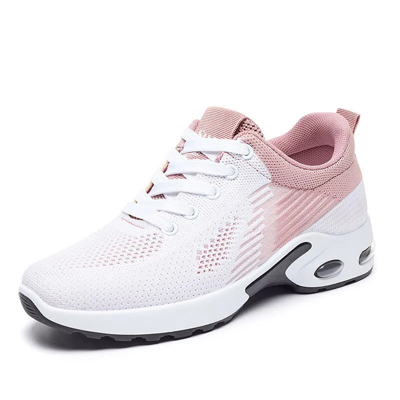 Women's pink Flyknit casual running shoes with mesh lining and flat PVC sole on a white background.