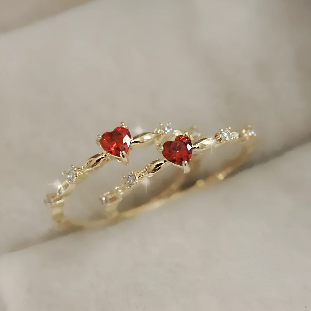 Gold or silver electroplated peach heart ring with zircon stones on a model's hand