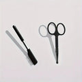 Black dual-head pet grooming brush with soft silicone bristles and a comb for eye cleaning and hair removal.