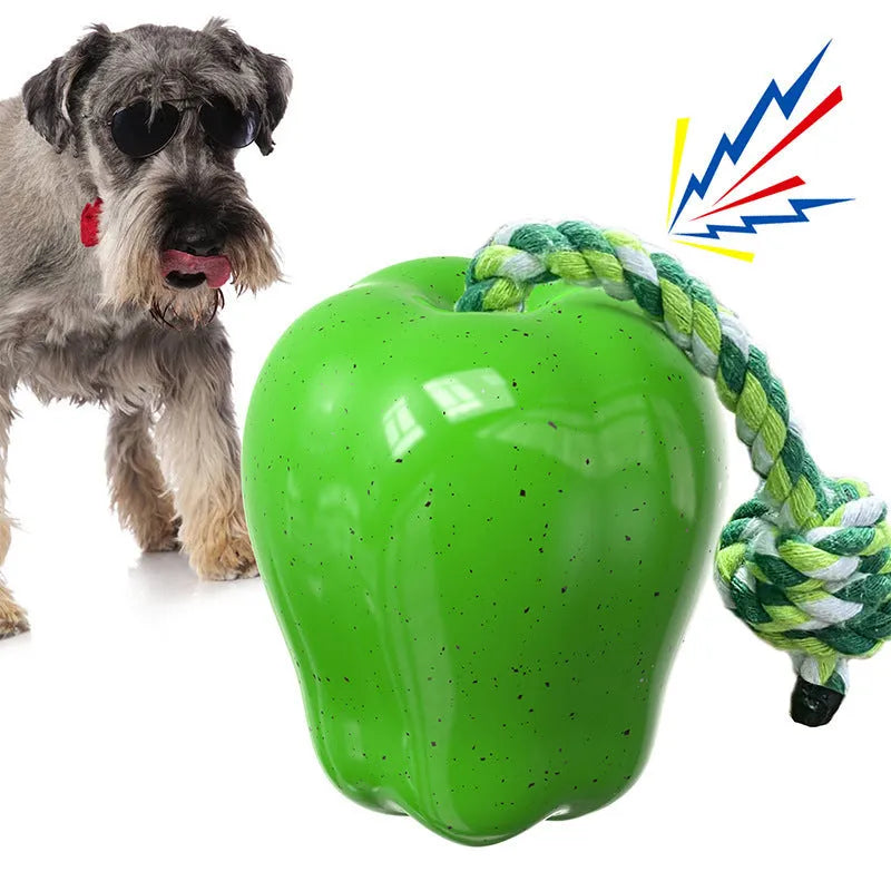Green and red plastic apple-shaped dog toy with treat-dispensing ball and squeaky features