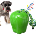 Green and red plastic apple-shaped dog toy with treat-dispensing ball and squeaky features