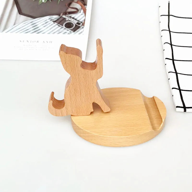 Solid beech wood mobile phone stand with a decorative resin animal ornament and a coin slot.