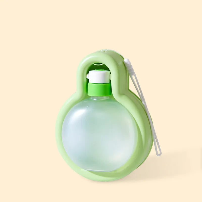 Green dog travel water bottle with pull-out drinking bowl for outdoor use with pets
