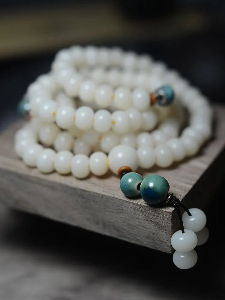 White Jade Bodhi Root bracelet with 108 flat round beads, shown in two size options.