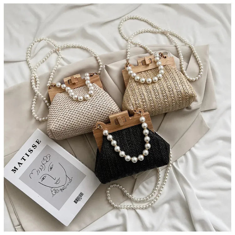 Women's straw shoulder bag with pearl chain detail and multiple zipper compartments in neutral colour