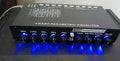 Black car audio EQ tuning amplifier with control knobs for subwoofer and seven-band equaliser.