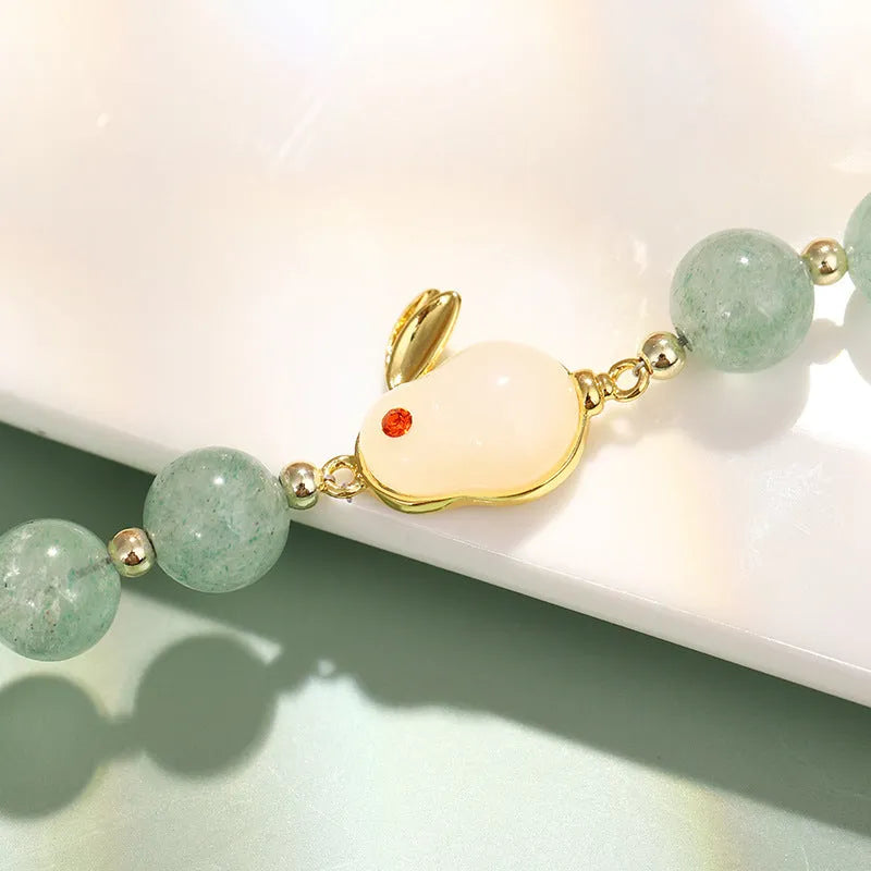 Rabbit motif bracelet with green aventurine and strawberry quartz stones in gold and copper setting