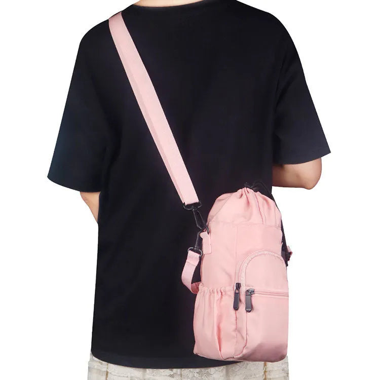 Cloth water bottle shoulder bag in black, green, or pink colours with a drawstring closure.