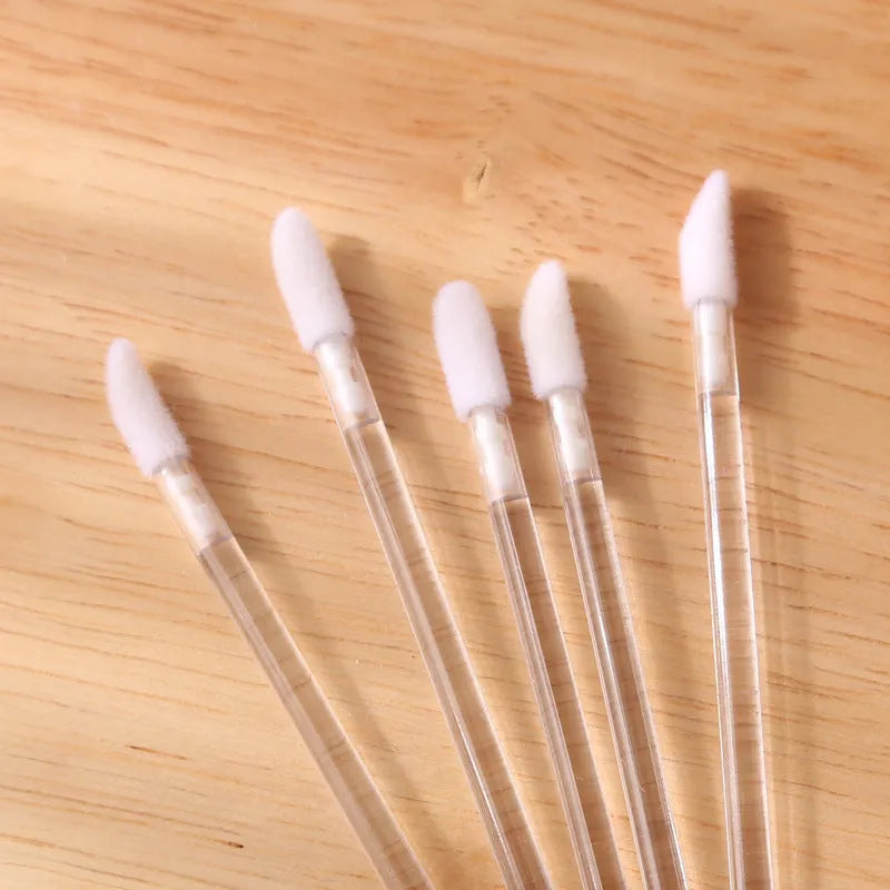 Disposable lip brushes with flocked tips and black handles in multiple colours