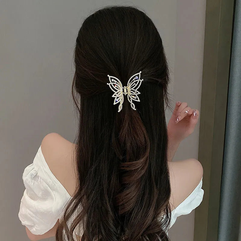 Butterfly-shaped alloy hair clip barrette for women, available in rhinestone and pearl styles.