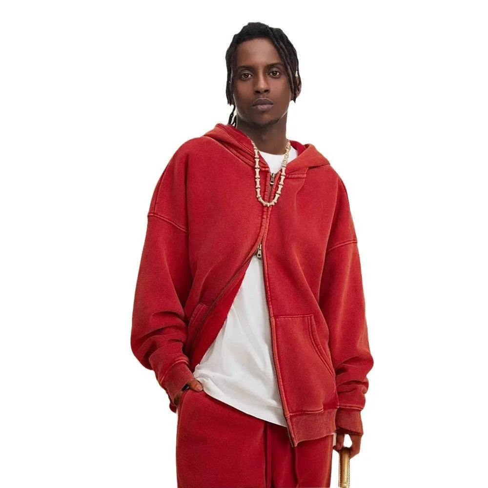 Man wearing a washed black fleece-lined hooded cardigan with a double zipper front.