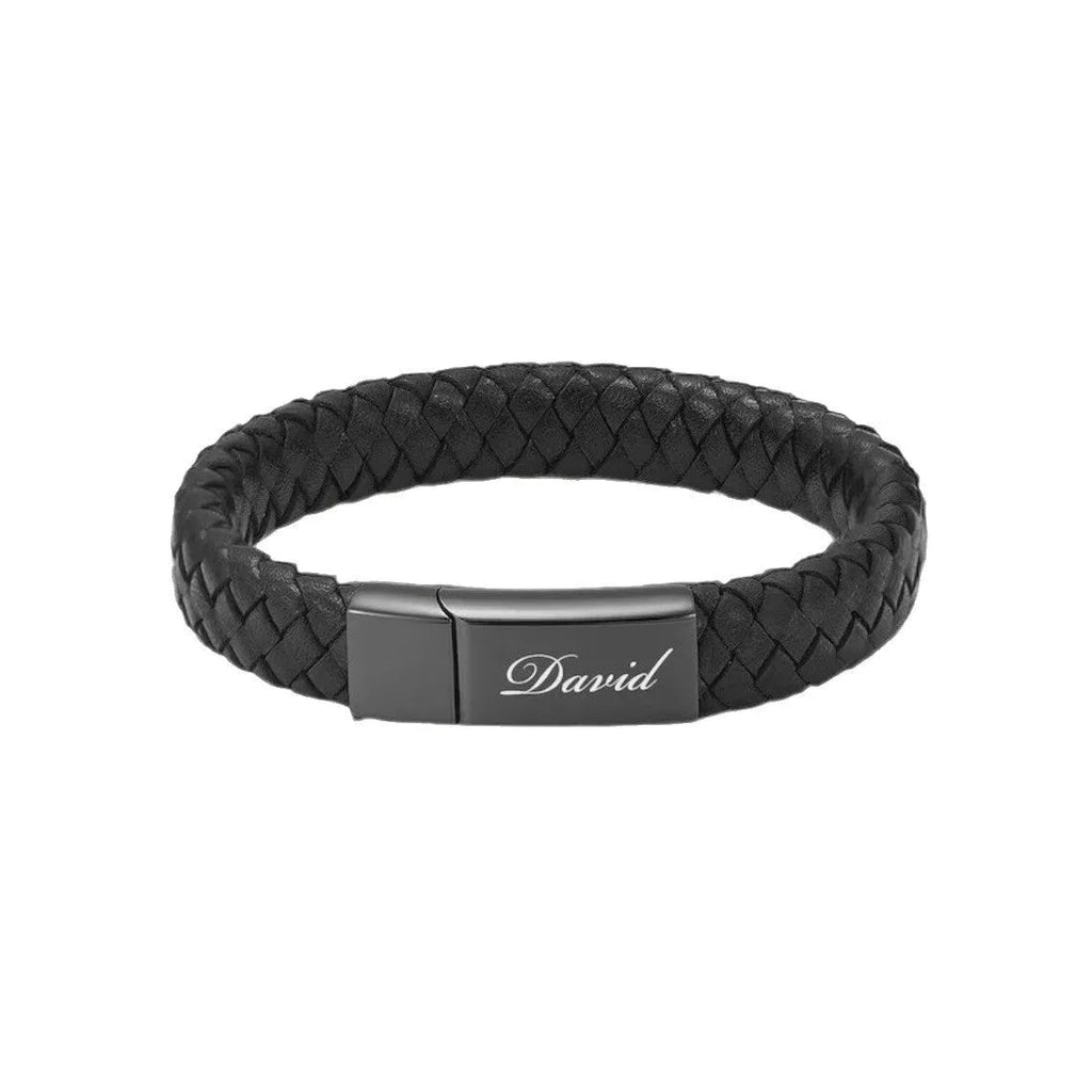 Black leather bracelet with a small stainless steel casket charm, shown in a gift box.