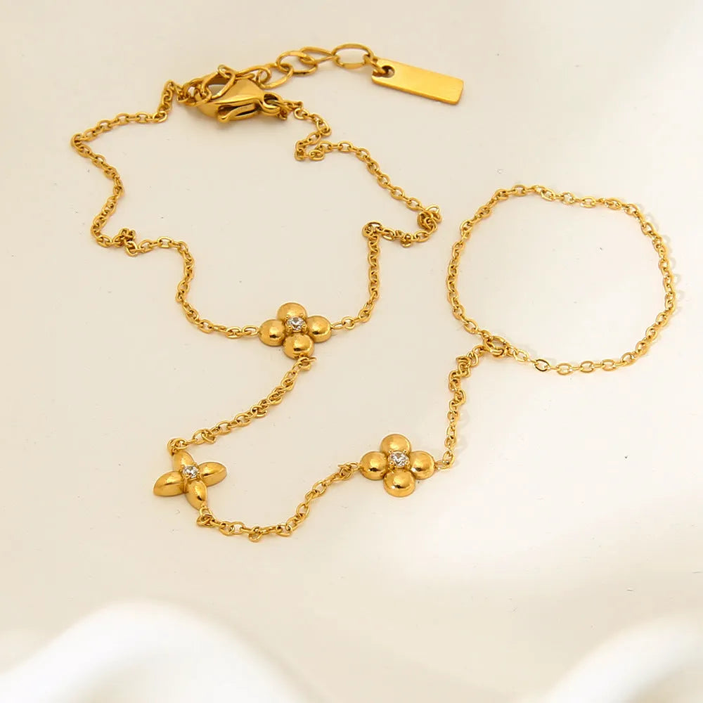 Gold stainless steel women's bracelet with geometric flower and eight-pointed star design.