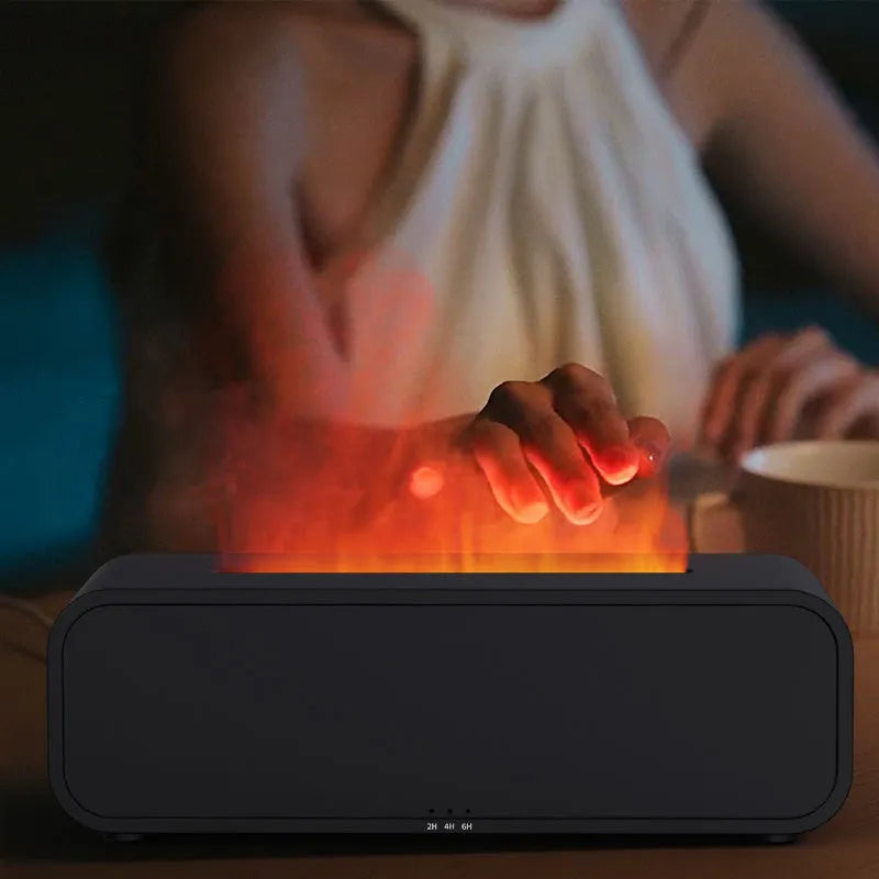 Black and white USB aroma diffuser with remote control and colour-changing lights on a wooden surface