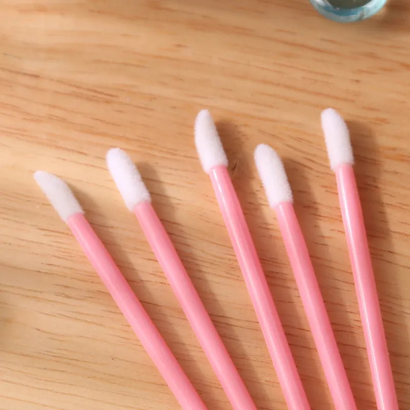 Disposable lip brushes with flocked tips and black handles in multiple colours