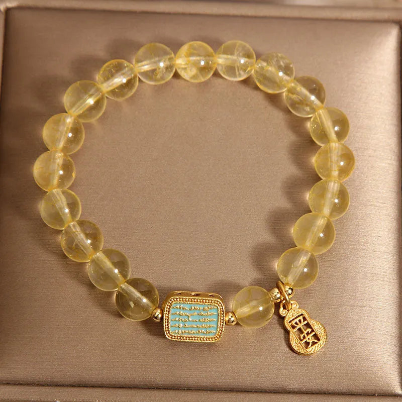 Women's yellow citrine crystal bracelet with rhinestone detailing on wrist