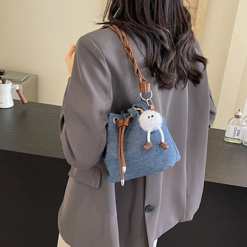 Blue synthetic leather cross body bucket bag with sandwich pocket organisation