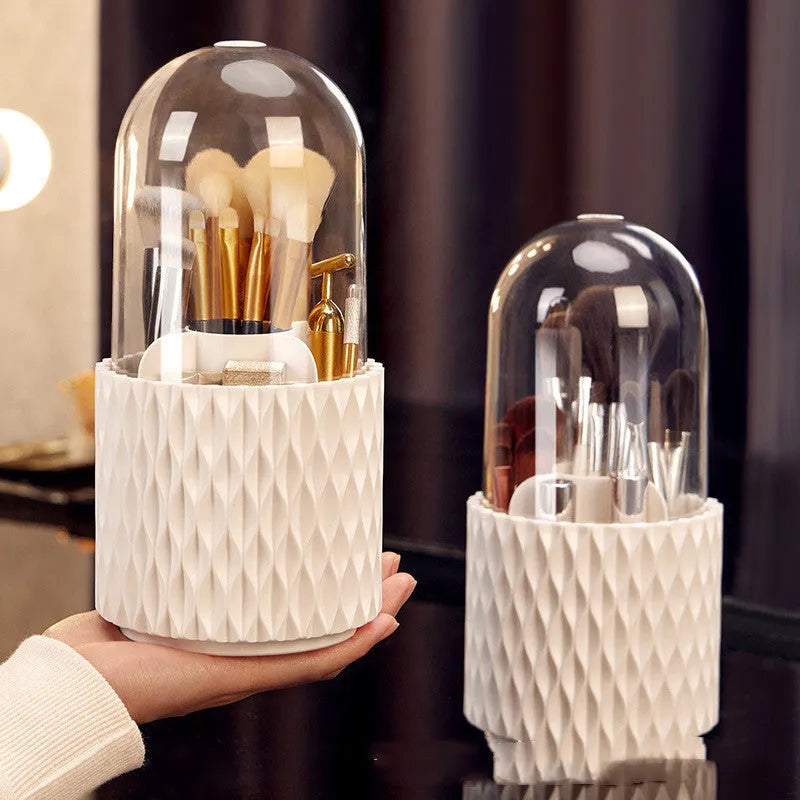 White transparent acrylic makeup brush holder with lid on a desktop, showing rotating base.