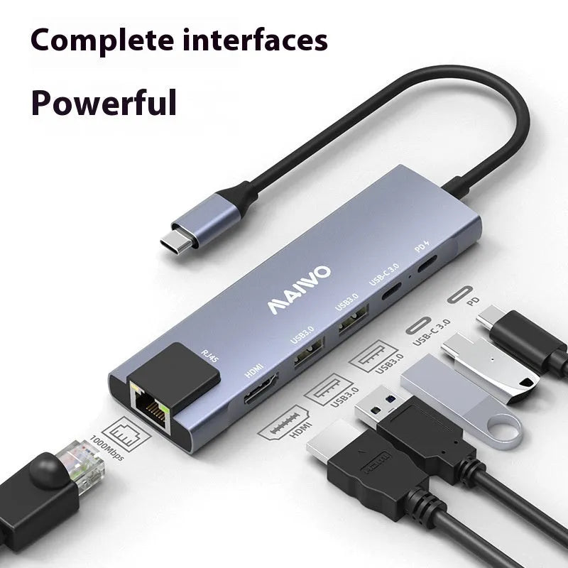 Steam Deck six-in-one aluminium docking station with HDMI, USB, and ethernet ports on a desk.