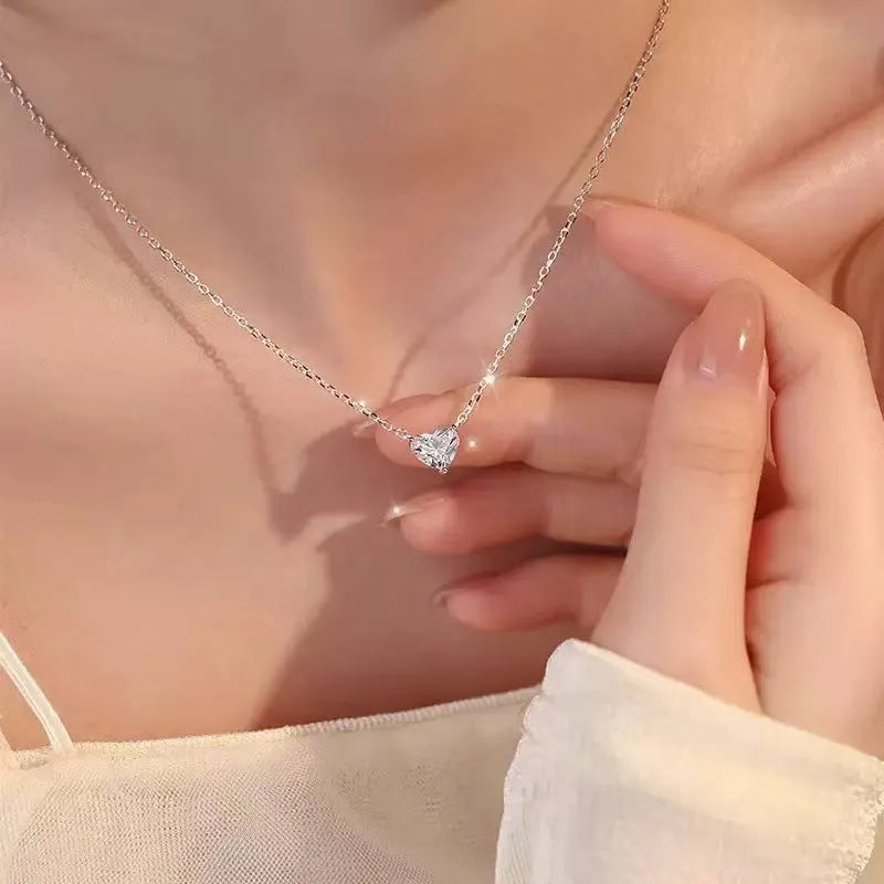 Women's simple copper necklace with silver heart-shaped pendant on display