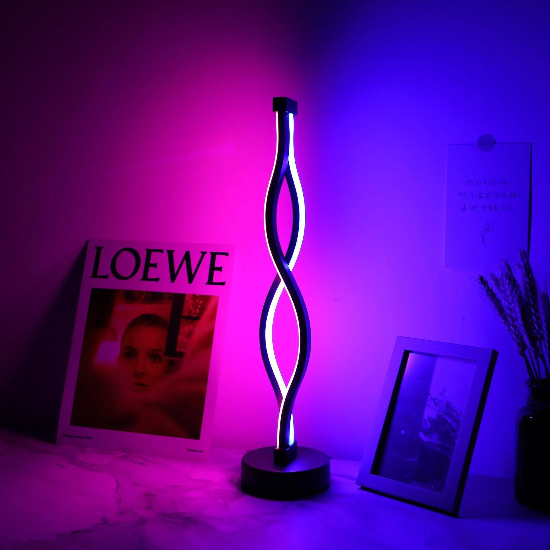 Black aluminium desk lamp with touch and button dimming controls on a desk.