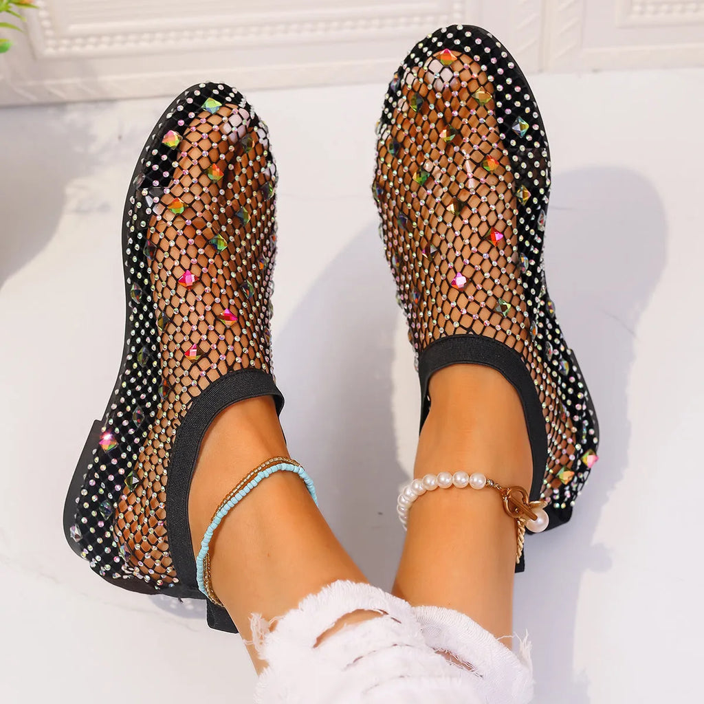 Women's flat sandals with colourful rhinestones on a mesh upper and rubber sole.