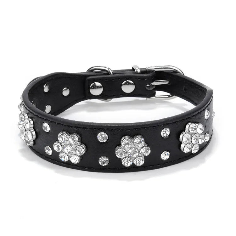 Soft black PU leather dog collar with a sparkling rhinestone flower pattern and silver metal studs, showing the adjustable eyelets and D-ring.