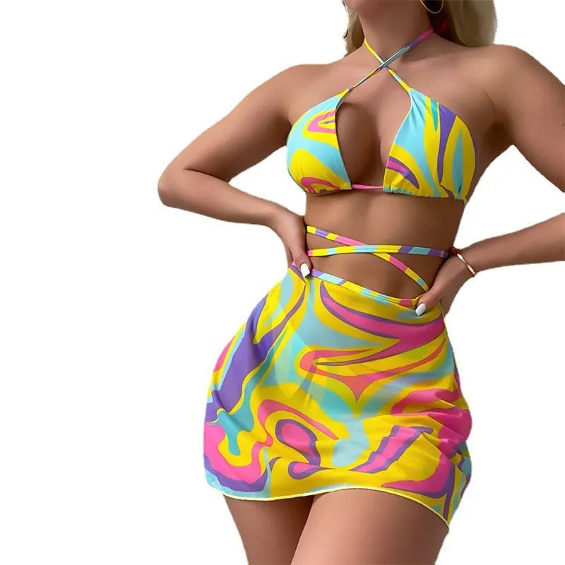 Yellow striped halter lace-up swimsuit for women with matching skirt and shorts.
