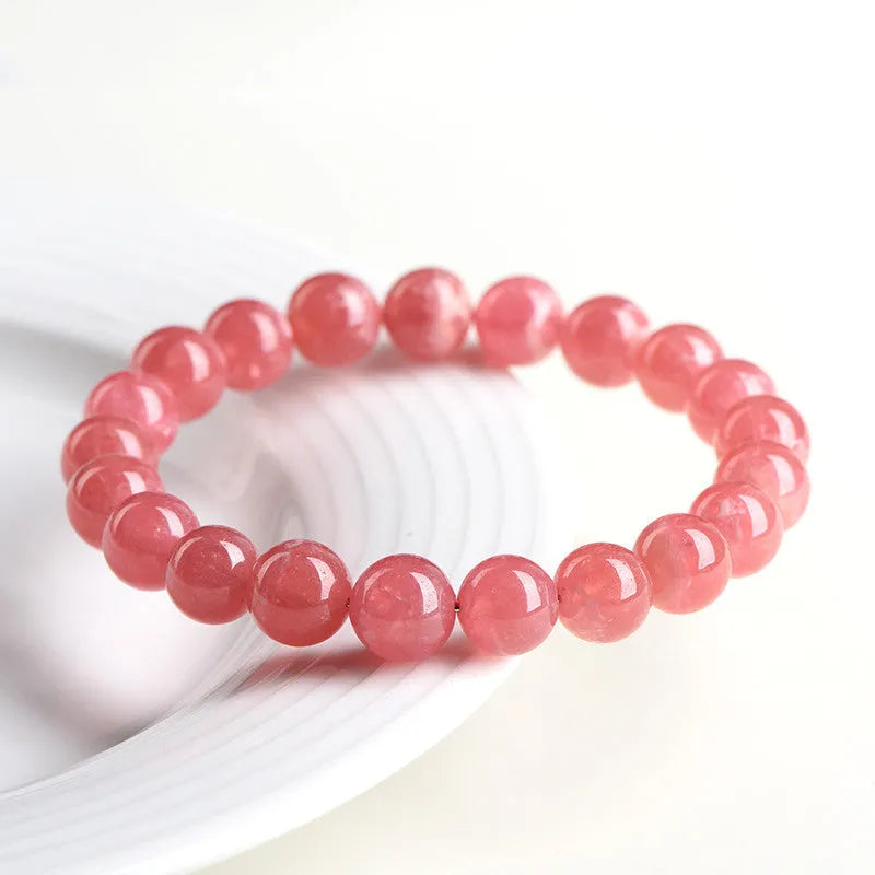 Women's geometric crystal bracelet with longevity lock in natural red rhodochrosite patterns showing angular bead shapes