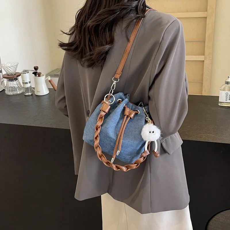 Blue synthetic leather cross body bucket bag with sandwich pocket organisation
