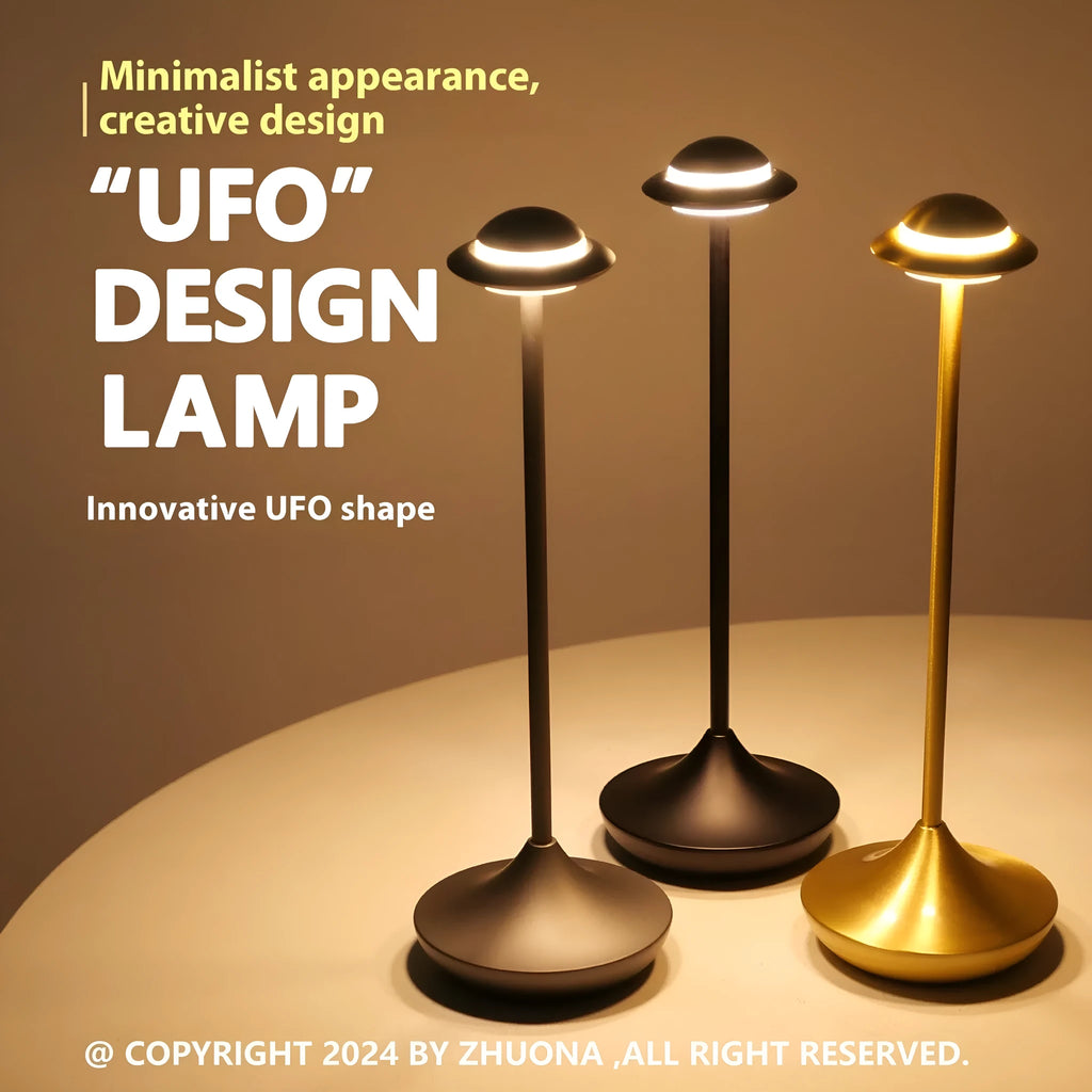 Metallic gold UFO-shaped table lamp with touch dimming on a wooden desk.