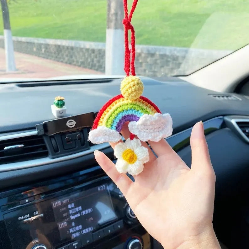 Handmade crocheted avocado with rainbow flower car pendant in wool yarn.