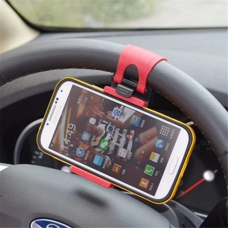 Black steering wheel phone holder mounted showing elastic clip and silicone phone padding
